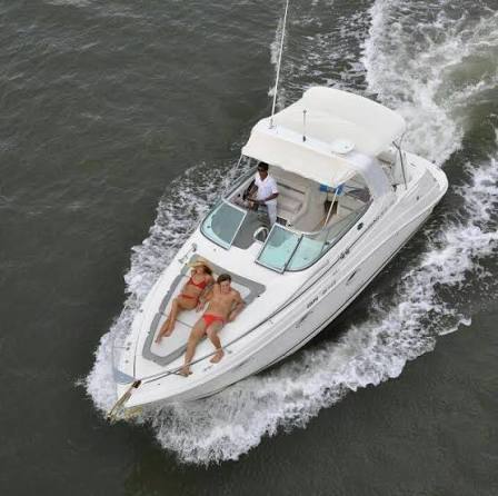 Guests sunbathing on the front deck of a speeding yacht